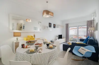 a kitchen with a wooden table and a white door at Boat Apartments Old Town by Ocvillas in Albufeira