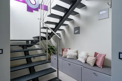 a staircase in a living room with a bench at Vitoria 7th hole by SAPvillas in Vilamoura