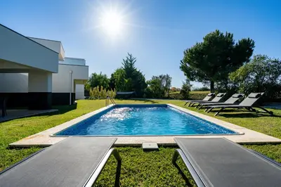 a swimming pool in the yard of a house at Vitoria 7th hole by SAPvillas in Vilamoura