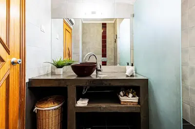 a bathroom with a sink and a mirror at Ground floor with direct access to swimming pool in Albufeira