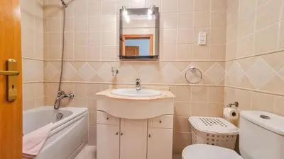 a bathroom with a sink and a toilet at Golfview Apartment in Quarteira