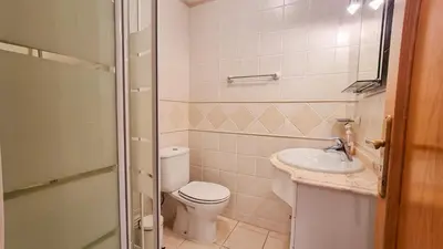 a small bathroom with a toilet and a sink at Golfview Apartment in Quarteira