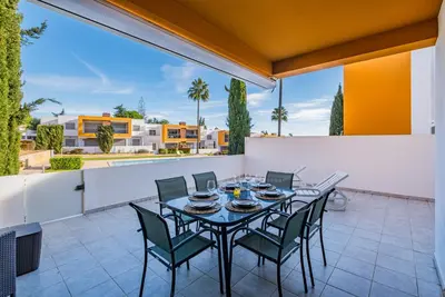 a patio with a table and chairs on a balcony at Vitismar Praia Algarve in Guia