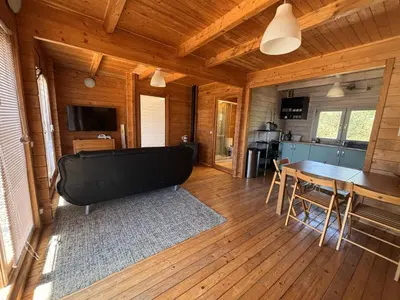 a living room with a table and a kitchen at Casa na Colina in Almancil