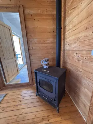 a stove in a room with a wooden wall at Casa na Colina in Almancil