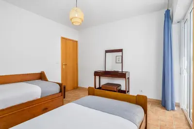 a bedroom with two beds and a mirror at Bright 3BDR Vilamoura Retreat Flat by LovelyStay in Quarteira