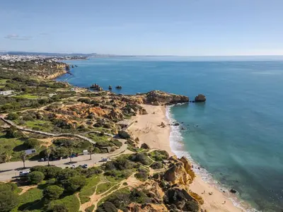 an aerial view of a beach and the ocean at Palm Breeze Retreat in Albufeira w Pool and Balcony by Lisbeyond in Albufeira