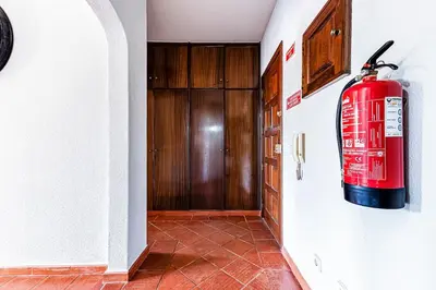 a fire hydrant hanging on a wall in a hallway at 5-minute walk to Aveiros Beach in Albufeira