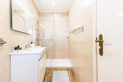 a bathroom with a tub and a sink and a shower at 5-minute walk to Aveiros Beach in Albufeira