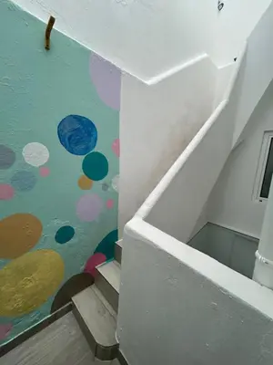 a staircase with a mural of planets on the wall at Dolce Faro Niente Guest House in Faro