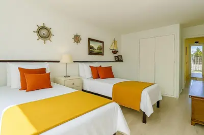 a bedroom with two beds with orange and white at Villa Mar by Sunny Deluxe in Albufeira