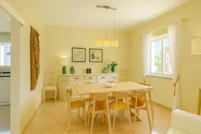 a dining room with a table and chairs at Villa Mar by Sunny Deluxe in Albufeira