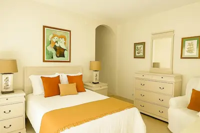 a bedroom with a bed with orange pillows at Villa Mar by Sunny Deluxe in Albufeira