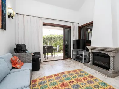 a bedroom with a bed and a flat screen tv at Akivillas Albufeira Now in Olhos de Água