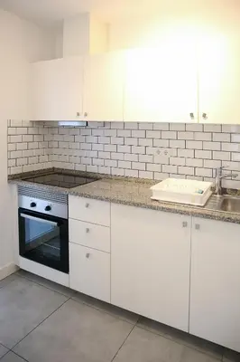 a bathroom with a sink and a toilet and a mirror at Casa Tomás in Faro