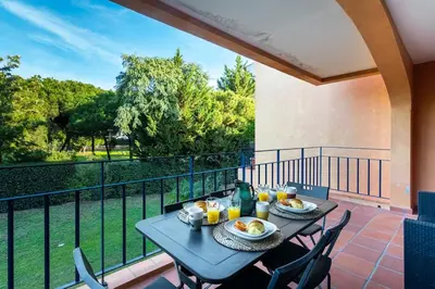 a table with two plates of food on a balcony at F5 Vila Sol G Pool & Golf in Vilamoura in Quarteira