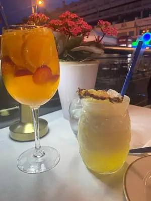 a glass of orange juice and a drink on a table at Solar Vilamoura Relaxing Apartment Stay in Quarteira