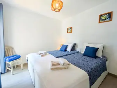 two beds in a room with blue and white at Sunny Condo facing the pool by Algarve Dream Holidays in Quarteira