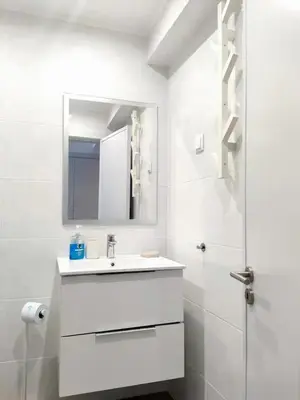 a bathroom with two sinks and a large mirror at Sunny Condo facing the pool by Algarve Dream Holidays in Quarteira