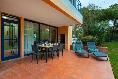 a patio with a table and chairs on a patio at F5 Vila Sol AP Pool & Golf in Vilamoura in Quarteira