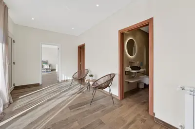 a room with two chairs and a table and a mirror at Villa Joya in Almancil