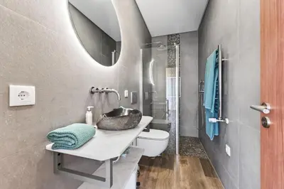 a bathroom with a sink and a toilet and a mirror at Villa Joya in Almancil
