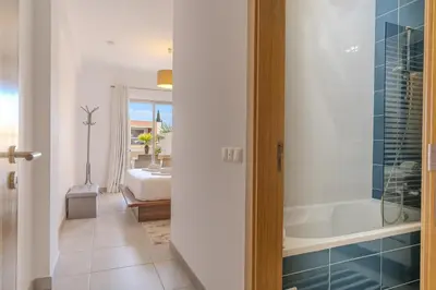 a bedroom with a bed and a lamp on a table at #354 Vitismar AU by Home Holidays in Guia