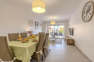 a dining room with a table with food and a clock at #354 Vitismar AU by Home Holidays in Guia