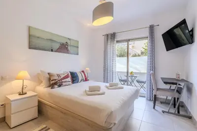 a living room with a couch and a table at #354 Vitismar AU by Home Holidays in Guia