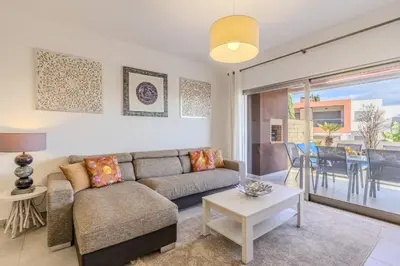 a white bedroom with a large bed and a window at #354 Vitismar AU by Home Holidays in Guia