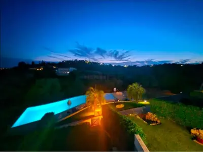 a sunset over a villa with a swimming pool at Terras Novas Paradise - Albufeira in Albufeira