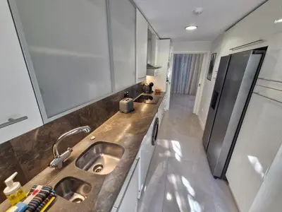 a kitchen with a stainless steel refrigerator and a sink at Terras Novas Paradise - Albufeira in Albufeira