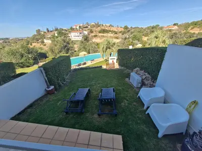 a patio with a bench on a deck at Terras Novas Paradise - Albufeira in Albufeira