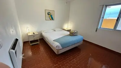 a small bedroom with a bed and a window at Blife Josya private apartment at Faro beach in Faro