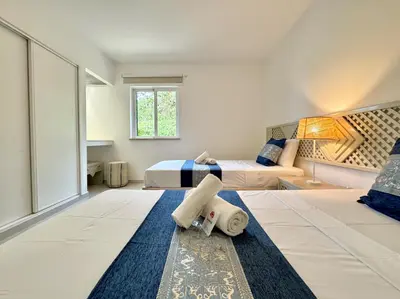 a bedroom with two beds and a large window at Albufeira Balaia Golf Vilage 8 With Pool by Homing in Albufeira