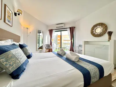a bedroom with a large white bed with blue pillows at Vilamoura Central Beach 1 With Pool by Homing in Vilamoura