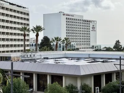 a large white building with palm trees in front of it at Vilamoura Central Beach 1 With Pool by Homing in Vilamoura