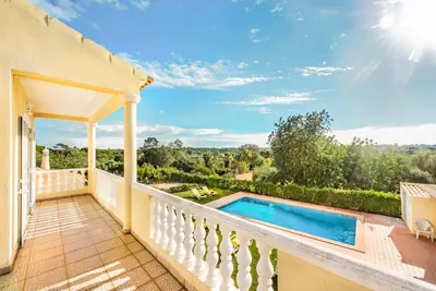 a view from the balcony of a house with a swimming pool at Villa Portela in Loulé