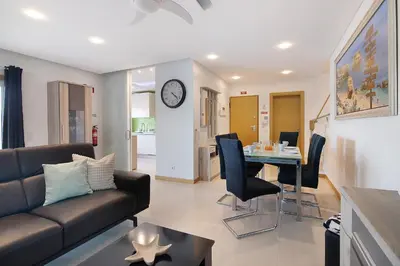 a living room with a couch and a table at Flat With Pool, Old Town Albufeira in Albufeira