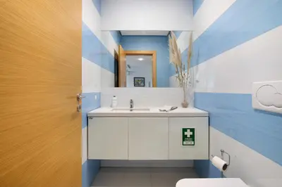 a bathroom with a white sink and a mirror at Flat With Pool, Old Town Albufeira in Albufeira
