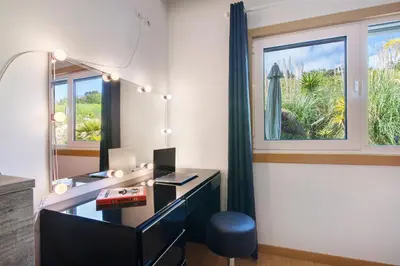 an office with a desk with a mirror and a window at Flat With Pool, Old Town Albufeira in Albufeira