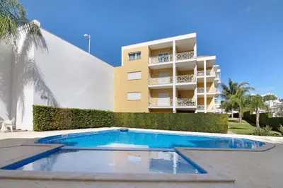 a building with a swimming pool in front of a building at Flat With Pool, Old Town Albufeira in Albufeira