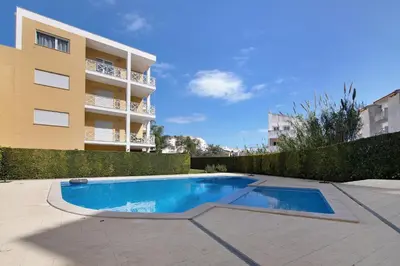 a swimming pool in front of a building at Flat With Pool, Old Town Albufeira in Albufeira