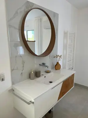 a bathroom with a white sink and a mirror at Casa Alegria in Tunes
