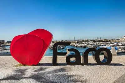 an empty street with tables and chairs and buildings at Faro Downtown in Faro