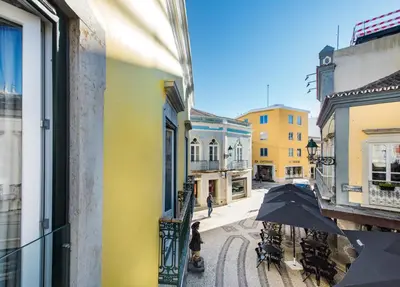 a white kitchen with a sink and a stove at Faro Downtown in Faro