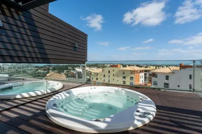 a living room with a couch and a chair at Penthouse Grand Noir in Guia