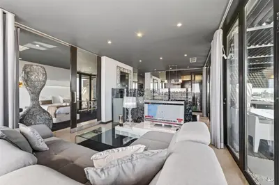 a resort with a swimming pool and palm trees at Penthouse Grand Noir in Guia