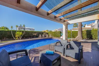 a patio with chairs and a swimming pool at Villa Gale by Vintage Travel in Galé