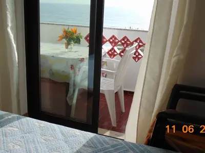a room with a table with a view of the ocean at Apartment NASCER-DO-SOL by Interhome in Quarteira